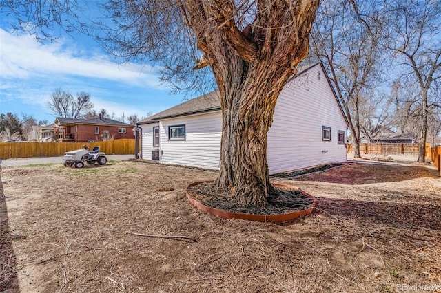 view of side of property featuring fence