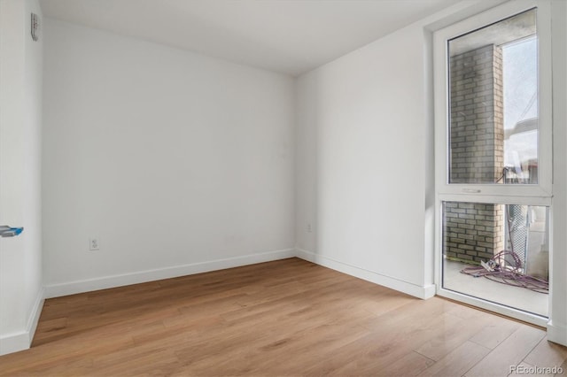 spare room with light hardwood / wood-style flooring