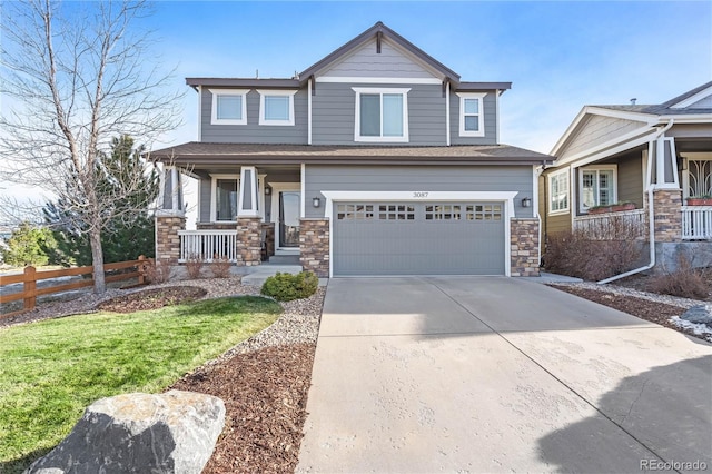 craftsman-style home with a front yard, a porch, and a garage