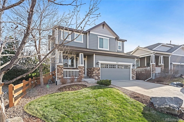 craftsman-style home featuring a garage, covered porch, and a front lawn