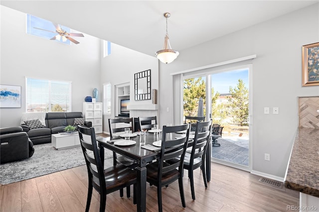 dining area featuring hardwood / wood-style floors, ceiling fan, and a wealth of natural light