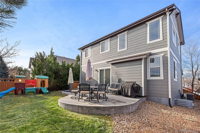 back of property featuring a patio, a yard, a playground, and central AC