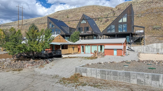 rear view of property featuring a mountain view