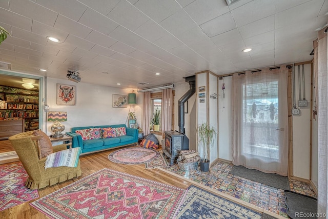 living room with hardwood / wood-style floors and a wood stove