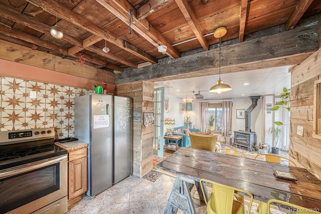 kitchen with wood ceiling, stainless steel appliances, beam ceiling, a wood stove, and hanging light fixtures