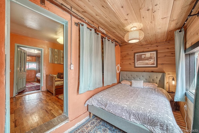 bedroom featuring hardwood / wood-style floors, wood walls, and wood ceiling