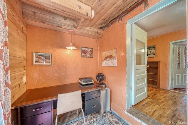 office with radiator, wooden ceiling, light hardwood / wood-style flooring, and built in desk