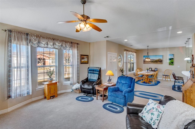 living area featuring carpet floors, recessed lighting, visible vents, ceiling fan, and baseboards