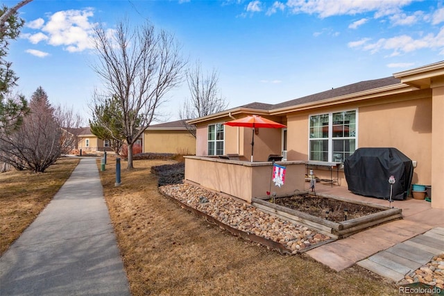 exterior space with a patio area and stucco siding