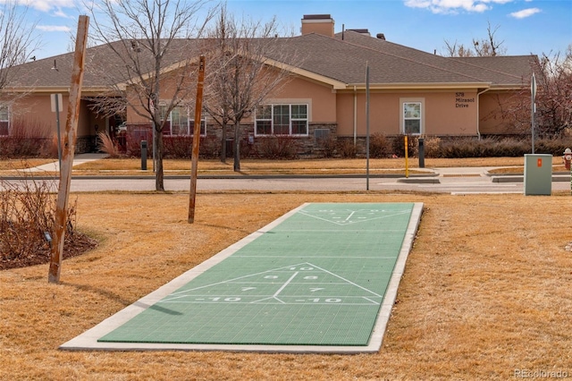 view of property's community featuring shuffleboard