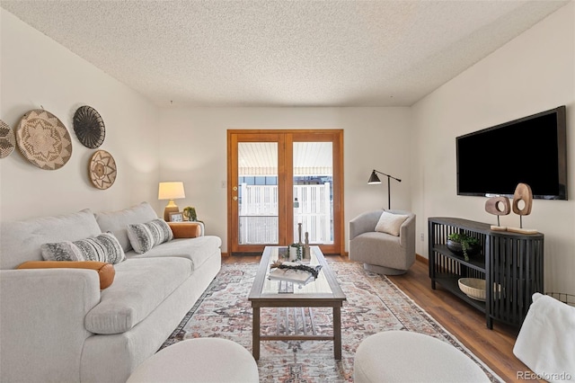 living room featuring a textured ceiling and wood finished floors