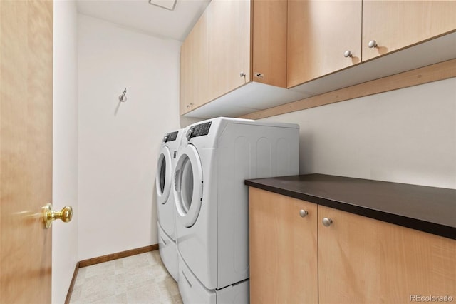 laundry area with light floors, washing machine and dryer, cabinet space, and baseboards