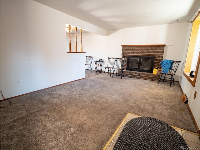 living area with baseboards, carpet, and a fireplace