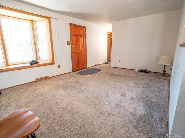 interior space with visible vents, carpet floors, and baseboards