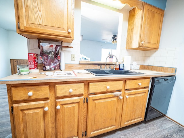 kitchen featuring ceiling fan, dishwasher, light countertops, decorative backsplash, and a sink