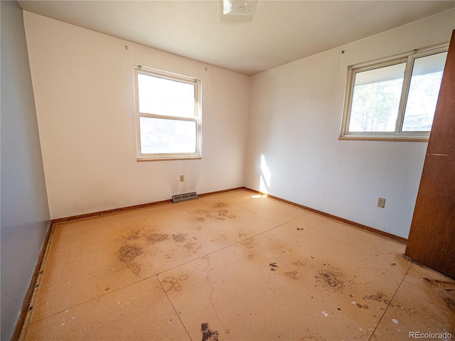 unfurnished room featuring visible vents and baseboards