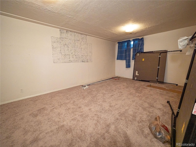 carpeted empty room with a textured ceiling