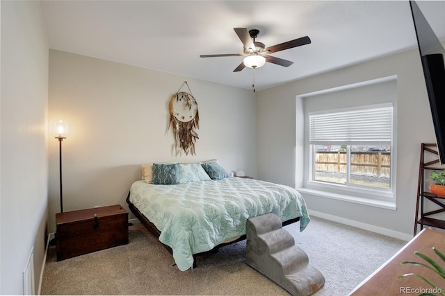 bedroom with ceiling fan, carpet flooring, and baseboards