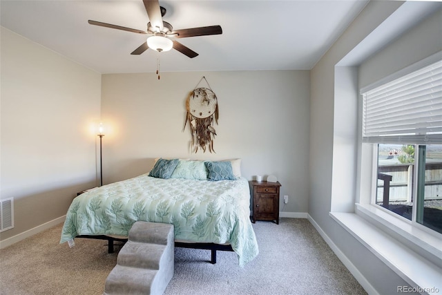 carpeted bedroom featuring visible vents, a ceiling fan, and baseboards