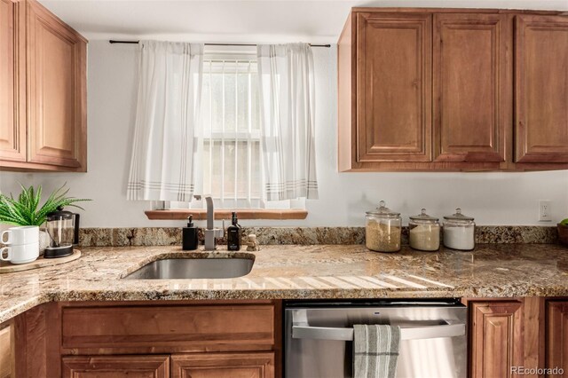 2028 Perry St, Denver, CO 80212 - kitchen featuring stainless steel dishwasher, a sink, brown cabinetry, and light stone counters