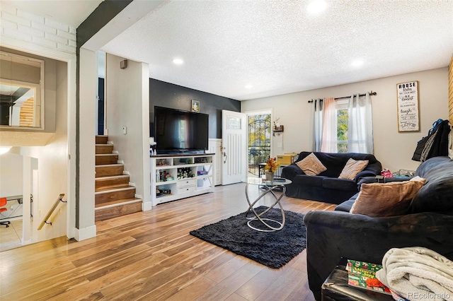 living room featuring a textured ceiling and light hardwood / wood-style flooring