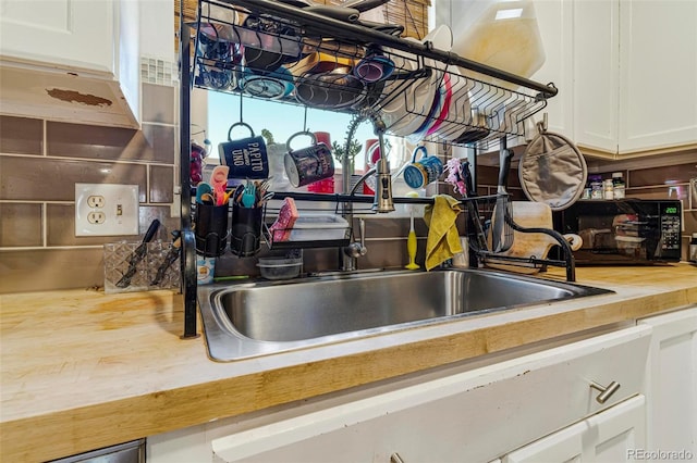 room details with white cabinetry and sink