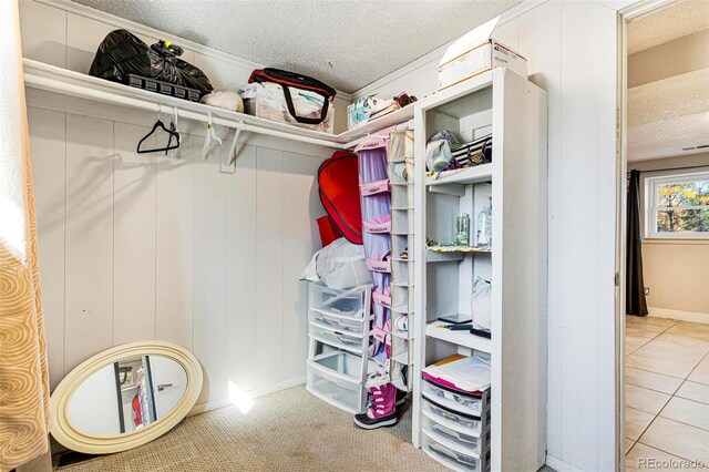 walk in closet with light tile patterned flooring