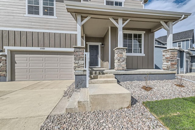 view of exterior entry with a porch and a garage