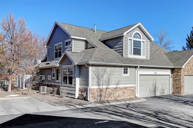 view of home's exterior featuring central AC and a garage