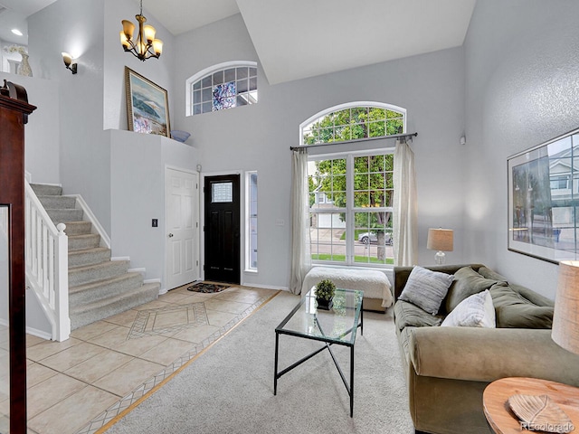 8838 S Dudley St, Littleton, CO 80128 - living room with a towering ceiling, a chandelier, baseboards, stairs, and tile patterned flooring