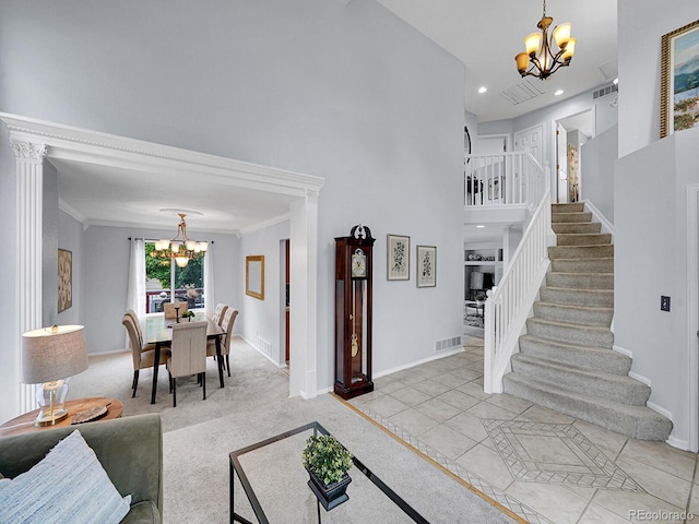 8838 S Dudley St, Littleton, CO 80128 - entryway featuring a chandelier, stairway, a towering ceiling, baseboards, and crown molding