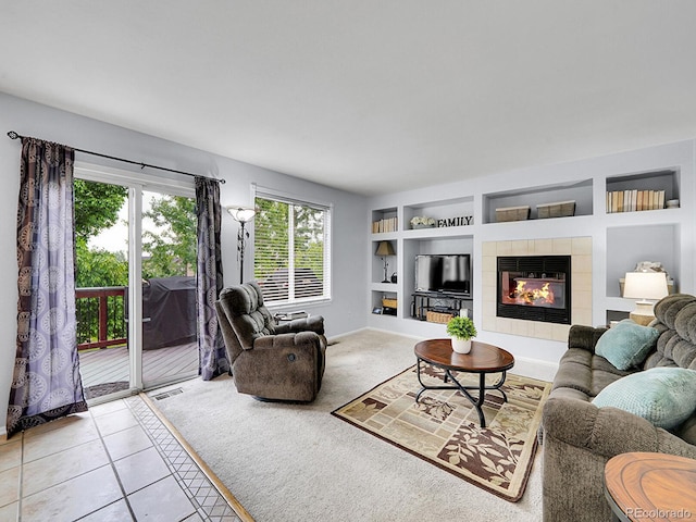 8838 S Dudley St, Littleton, CO 80128 - tiled living room with built in shelves, baseboards, a tiled fireplace, and carpet