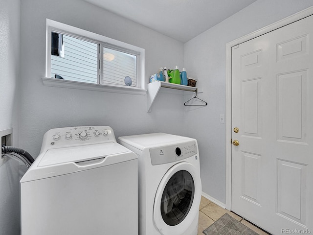 8838 S Dudley St, Littleton, CO 80128 - laundry area featuring independent washer and dryer, light tile patterned floors, and baseboards