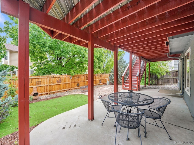 8838 S Dudley St, Littleton, CO 80128 - fenced backyard featuring a patio area, stairs, and outdoor dining space