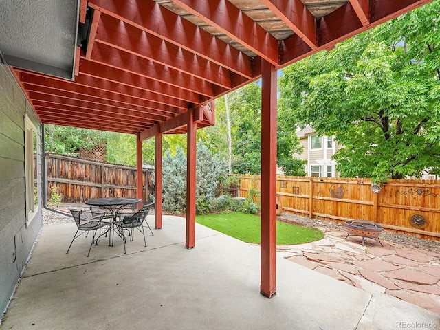 8838 S Dudley St, Littleton, CO 80128 - fenced backyard featuring an outdoor fire pit, a patio area, a pergola, and outdoor dining space