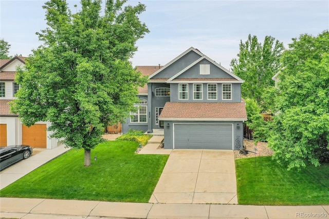 8838 S Dudley St, Littleton, CO 80128 - view of front of house with stucco siding, an attached garage, a front lawn, driveway, and a shingled roof