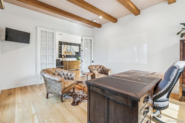 office space featuring french doors, light wood-type flooring, beam ceiling, and baseboards