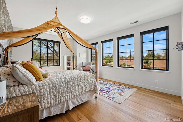 bedroom featuring wood finished floors and baseboards