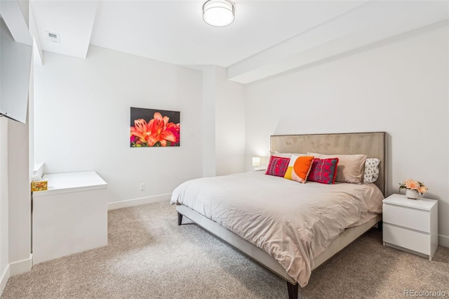 bedroom featuring carpet and baseboards