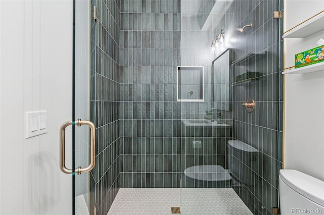 bathroom with toilet and a shower stall