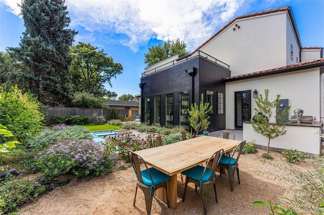 view of patio featuring fence and outdoor dining area