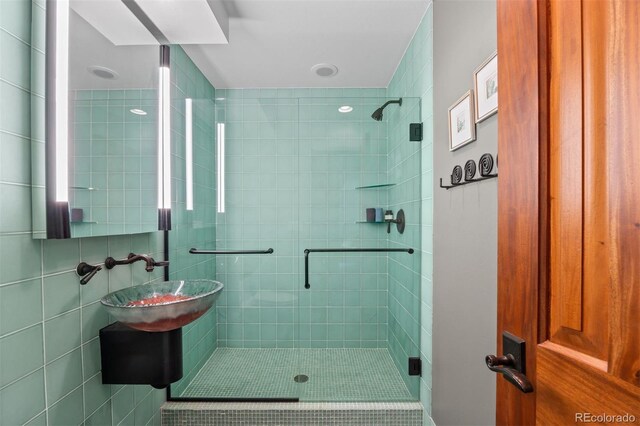 12653 Rancho Ct, Conifer, CO 80433 - bathroom featuring a stall shower and a sink