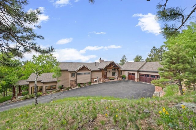 12653 Rancho Ct, Conifer, CO 80433 - view of front of home featuring a garage and asphalt driveway