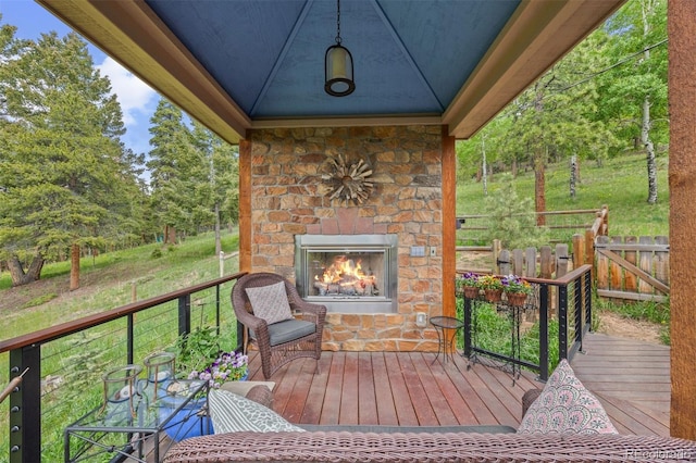 12653 Rancho Ct, Conifer, CO 80433 - wooden terrace featuring an outdoor stone fireplace