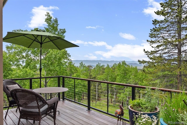 12653 Rancho Ct, Conifer, CO 80433 - wooden terrace featuring a wooded view and a mountain view