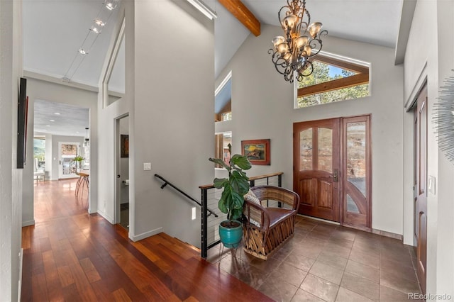 12653 Rancho Ct, Conifer, CO 80433 - entryway featuring beam ceiling, high vaulted ceiling, french doors, and a chandelier