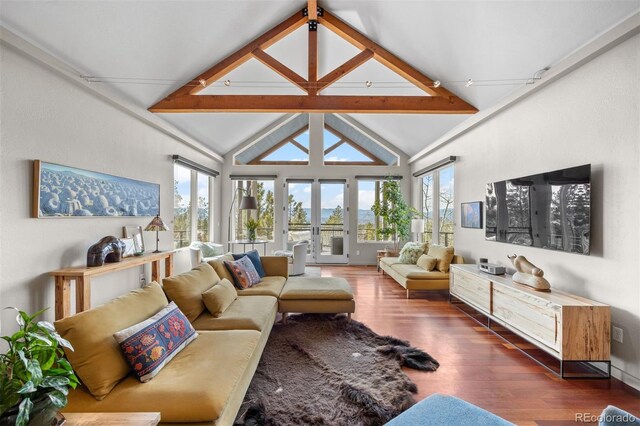 12653 Rancho Ct, Conifer, CO 80433 - living area featuring wood finished floors, beam ceiling, and high vaulted ceiling