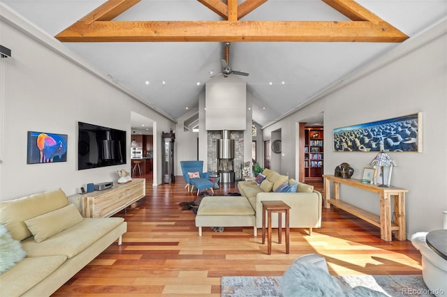 12653 Rancho Ct, Conifer, CO 80433 - living area featuring high vaulted ceiling, light wood-type flooring, beam ceiling, and a ceiling fan