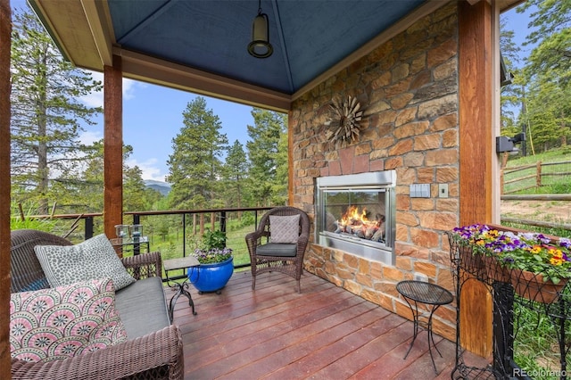 12653 Rancho Ct, Conifer, CO 80433 - deck with an outdoor stone fireplace