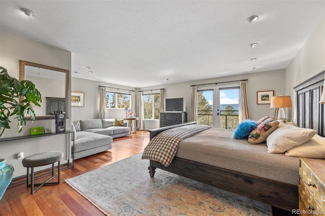 12653 Rancho Ct, Conifer, CO 80433 - bedroom featuring access to exterior, wood finished floors, and french doors